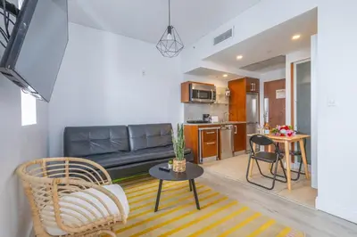 a living room with a couch and a table at Beautiful Studio with Rooftop pool B309 in Miami Beach