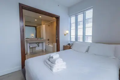 a bedroom with a white bed with towels on it at Beautiful Studio with Rooftop pool B309 in Miami Beach