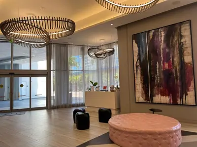 a living room with a round table and two chandeliers at Best Apartment next to Hollywood Beach 2B 2B in Hollywood