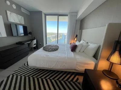 a bedroom with a large bed and a large window at Best Apartment next to Hollywood Beach 2B 2B in Hollywood