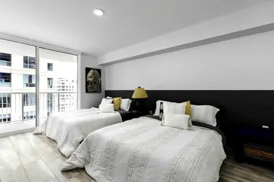 a bedroom with two beds and a large window at 1BR Brickell included Pool, Gym and Free Parking in Miami