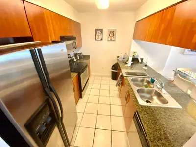 a kitchen with a sink and a refrigerator at 1BR Brickell included Pool, Gym and Free Parking in Miami