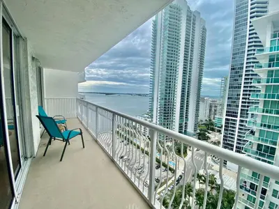 a balcony with a chair and a view of the ocean at 1BR Brickell included Pool, Gym and Free Parking in Miami