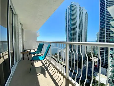 a balcony with two chairs and a view of a city at 1BR Brickell included Pool, Gym and Free Parking in Miami