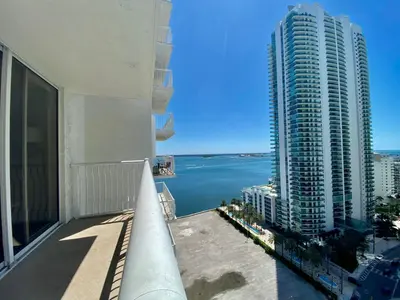 a view of the water from a balcony of a building at 1BR Brickell included Pool, Gym and Free Parking in Miami