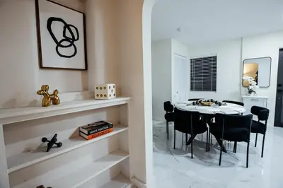 a dining room with a table and black chairs at Miami Palms Serene in Miami