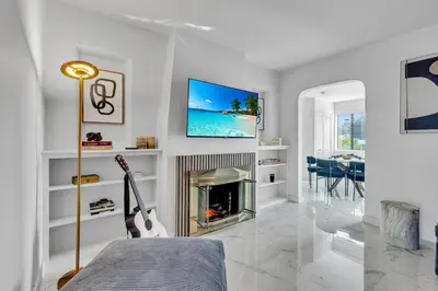 a living room with a guitar and a fireplace at Miami Palms Serene in Miami