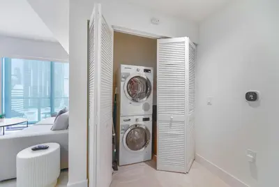 a room with a washer and dryer in a bedroom at Central Brickell Condo Walk to Shops & Dining in Miami