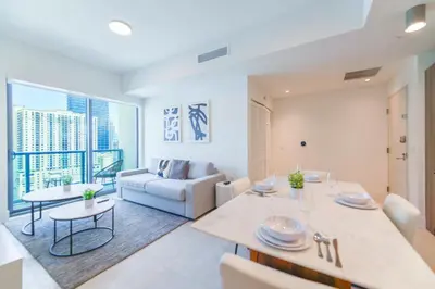 a living room with a couch and a table at Central Brickell Condo Walk to Shops & Dining in Miami