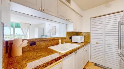 a kitchen with a sink and a microwave at Modern Luxury Condo Near Beach & Aventura Mall in Aventura