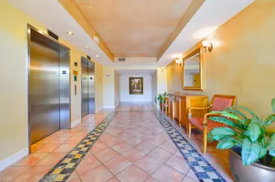 an empty hallway in a hospital with chairs and a corridor at Modern Luxury Condo Near Beach & Aventura Mall in Aventura