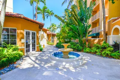 a fountain in a courtyard in front of a building at Modern Luxury Condo Near Beach & Aventura Mall in Aventura