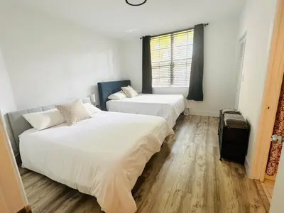 a bedroom with two beds and a window at Yacht Club Aventura 2 BR 2 Bath with Free Parking in Aventura