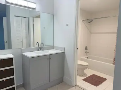 a white bathroom with a sink and a toilet at Yacht Club Aventura 2 BR 2 Bath with Free Parking in Aventura