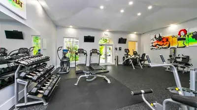a gym with several treadmills and cardio machines at Yacht Club Aventura 2 BR 2 Bath with Free Parking in Aventura
