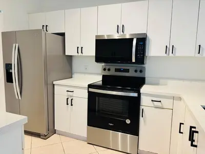 a kitchen with a microwave and a refrigerator at Yacht Club Aventura 2 BR 2 Bath with Free Parking in Aventura