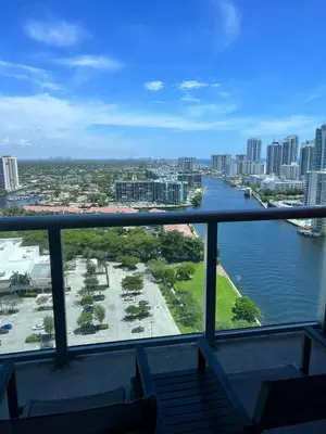 a view of a river from a balcony at Studio 2 beds queen, pool, gym and service beach in Hallandale Beach