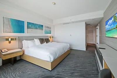 a bedroom with a large bed and a tv at Beachfront Ritz-Carlton Luxury 1BR Residence in Fort Lauderdale