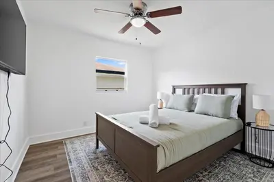 a bedroom with a bed with a ceiling fan at 4BR Escape Near Beach & Downtown in Fort Lauderdale