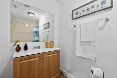 a white bathroom with a sink and a mirror at 4BR Escape Near Beach & Downtown in Fort Lauderdale
