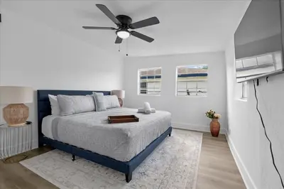 a bedroom with a bed with a ceiling fan at 4BR Escape Near Beach & Downtown in Fort Lauderdale