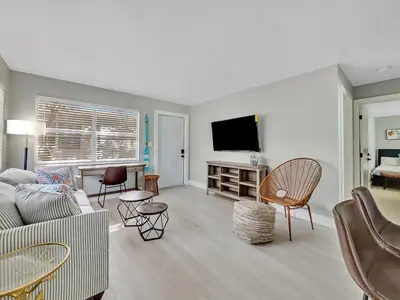 a living room with a couch and a tv at North Hollywood Beach 1BR | Walk to Ocean in Dania Beach