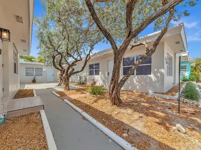 a house with trees in the front yard at Charming 1BR Escape Near Hollywood & Dania in Dania Beach