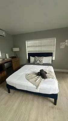 a bedroom with a bed with a blanket on it at Charming 1BR Escape Near Hollywood & Dania in Dania Beach