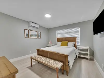 a bedroom with a large bed and a television at Hollywood Beach 1BR Getaway | WiFi + AC in Dania Beach