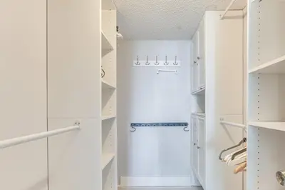 a white walk in closet with a refrigerator at Sunny isles Escape-1BR Condo Steps from the Beach! in Sunny Isles Beach