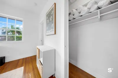 a living room with white walls and a shelf at Modern 1-BD Apt with Free Parking in Miami Beach