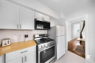 a white kitchen with a stove and a refrigerator at Modern 1-BD Apt with Free Parking in Miami Beach