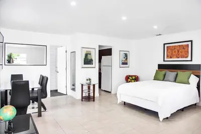 a bedroom with a bed and a table and chairs at Buena Vista-Miami Designer Studio # 1 in Miami