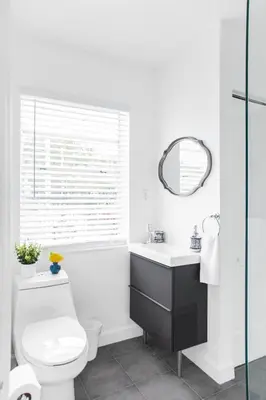 a bathroom with a toilet and a sink and a mirror at Buena Vista-Miami Designer Studio # 1 in Miami