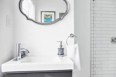 a white bathroom with a sink and a mirror at Buena Vista-Miami Designer Studio # 1 in Miami