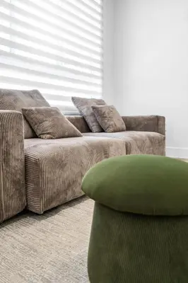 a living room with a couch and a green ottoman at #206 Brand-New 2BR- 2BA Near Brickell in Miami