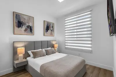 a bedroom with a bed with two lamps and a window at #206 Brand-New 2BR- 2BA Near Brickell in Miami