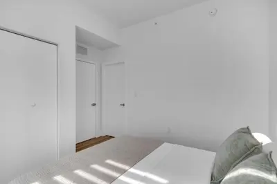 a white bedroom with a bed and white walls at #207 brand new 2BR 2BA near brickell and stadium Central location in Miami