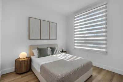 a white bedroom with a bed and a window at #207 brand new 2BR 2BA near brickell and stadium Central location in Miami