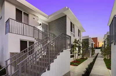 a white house with a metal staircase in front of it at #208 Brand New 2BR -2BA near marlins stadium in Miami