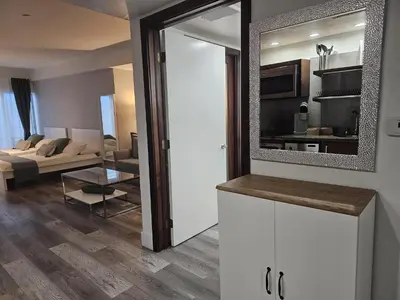 a living room with a couch and a mirror at Big studio with rooftop pool ocean view in Miami Beach