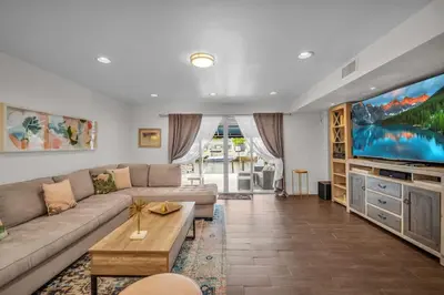 a living room with a couch and a large screen tv at Vista Mar Scenic 3BR Family Waterfront w Private Dock in North Miami