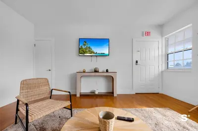 a living room with a chair and a fireplace at Spacious 1BD Beachside Apt with Free Parking in Miami Beach
