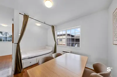 a room with a bed and a table and chairs at Spacious 1BD Beachside Apt with Free Parking in Miami Beach
