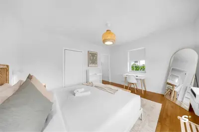 a white bedroom with a white bed and a mirror at Modern 1-BD Beachside Apt with Free Parking in Miami Beach