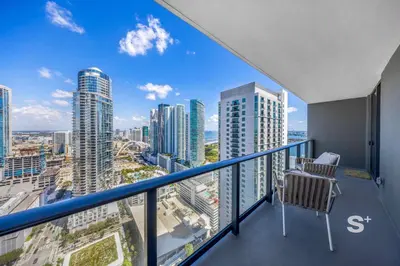 a balcony with two chairs and a view of the city at 2-BD Downtown Miami Condo with City Views in Miami
