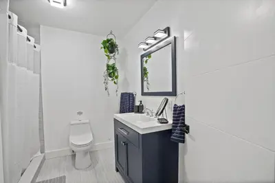 a white bathroom with a sink and a toilet at Luxury 1 bedroom apt in Kendall Prime Location in Westwood Lake