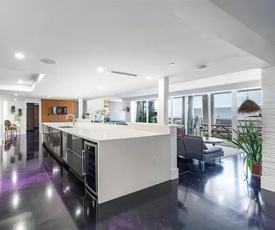 a kitchen with a white island in a living room at Luxury 3-Bedroom Bayview Retreat at The Grand Miami in Miami