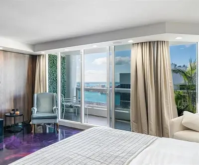 a bedroom with a bed and a view of the ocean at Luxury 3-Bedroom Bayview Retreat at The Grand Miami in Miami