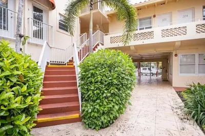 a house with a staircase in front of it at The Blue Octopus - 1br King Bed Condo in Fort Lauderdale